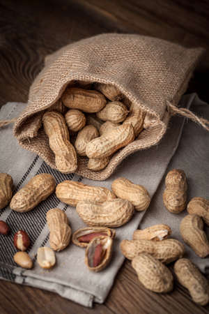 Peanuts in a burlap bag. Selective focus.の写真素材