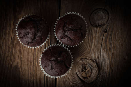 Chocolate muffin on dark background. Shallow depth of field. Top view.