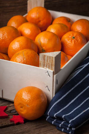 Fresh oranges in wooden box on a wooden background.の写真素材