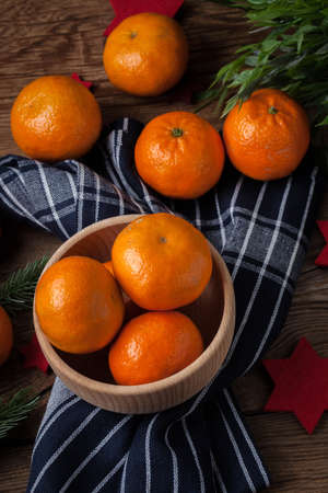 Fresh oranges in wooden bowl on a wooden background.の写真素材