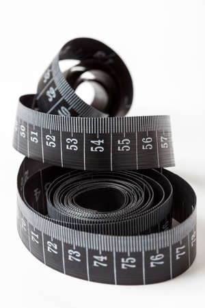 Black tape measuring isolated on a white background.の写真素材