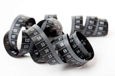 Black tape measuring isolated on a white background.の写真素材