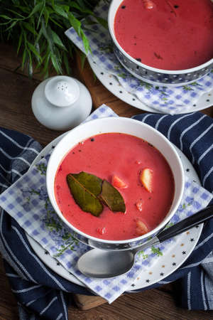 Vegetarian red soup - borsch in bowl on wooden background.の写真素材