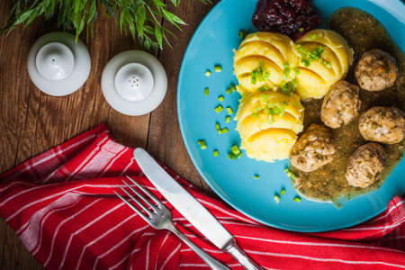 Meatballs in sauce with potatoes and cranberry jam. Top view.の写真素材