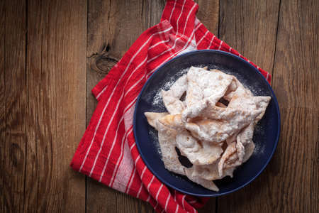 Faworki - angel wings cakes on a wooden table.の写真素材