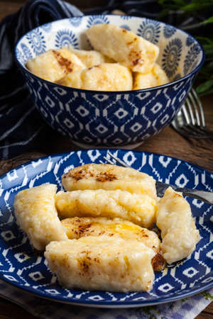 Lazy dumplings with cinnamon and sugar. Dark light.の写真素材