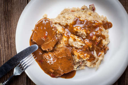 Braised in a sauce with cabbage with peas and bacon. Selective focus.の写真素材