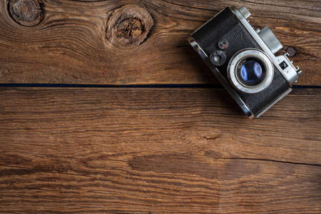 Vintage camera on wooden background. Copy space. Top view.の写真素材