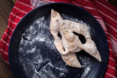 Faworki - angel wings cakes on a wooden table.の写真素材