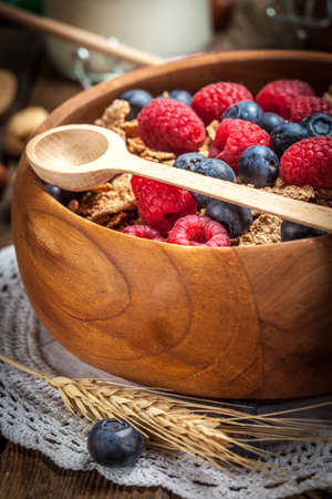 Tasty breakfast with milk and fruit in wooden bowl.の写真素材