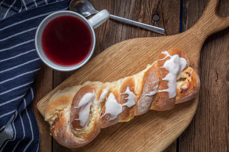 Braided sweet bun on a cutting board. Selective focus.の写真素材