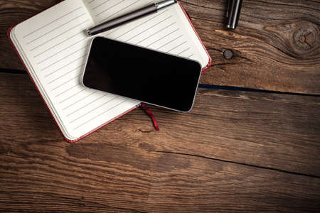 Opened blank notebook with elegant fountain pen on wooden background.の写真素材