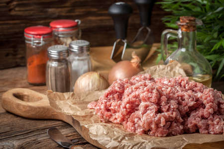 Raw minced meat on wooden background. Selective focus.の写真素材