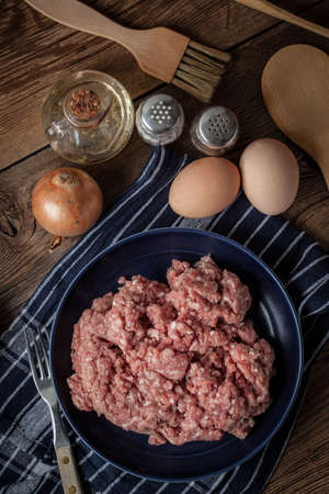Raw minced meat on wooden background. Selective focus.