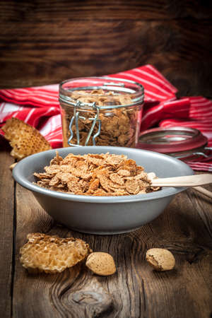 Healthy breakfast - bowl of cereals on a wooden table.