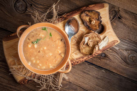 Mushroom soup on a wooden table. Top view.