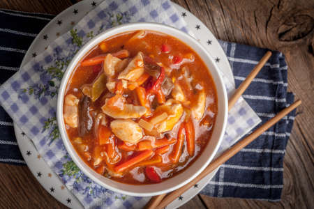Chinese chicken with vegetables on wooden table. Selective focus. Top view.の写真素材
