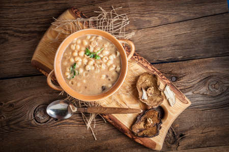 Mushroom soup on a wooden table. Top view.の写真素材