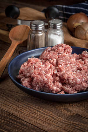 Raw minced meat on wooden background. Selective focus.
