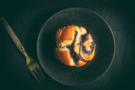 Home made yeast roll with chocolate. Dark light. Top view.の写真素材