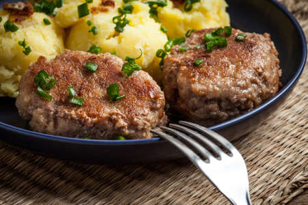 Meatballs served with boiled potatoes on a plate.の写真素材