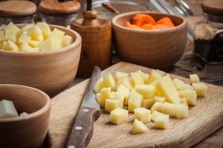 Sliced ingredients prepared to cook a tasty potato soup.の写真素材