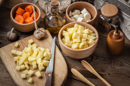Sliced ingredients prepared to cook a tasty potato soup.の写真素材