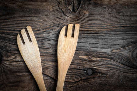 Wooden kitchen utensils on a wooden background. Copy space. Top view.の写真素材