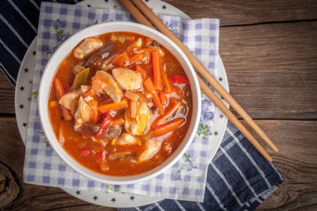 Chinese chicken with vegetables on wooden table. Selective focus.の写真素材