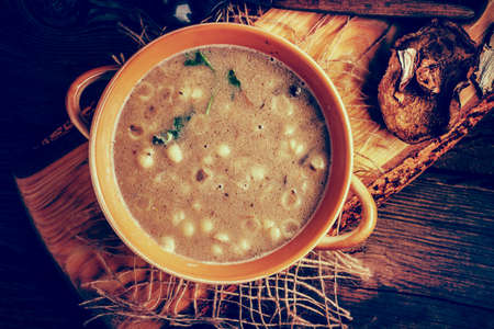 Mushroom soup on a wooden table. Top view. Instagram style filtred image.