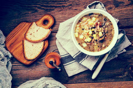 Sour rye soup with potatoes, mushrooms and smoked meat.の写真素材