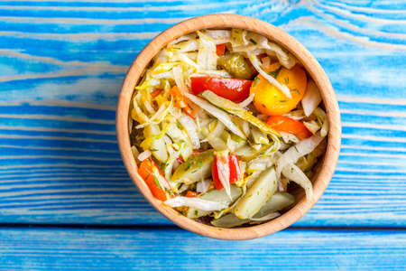 Homemade mixed vegetable winter pickles salad. Blue wooden background. Top view.の写真素材