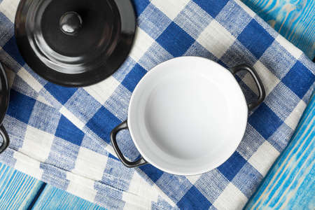 Mini black empty casserole on wooden table. Top view.の写真素材