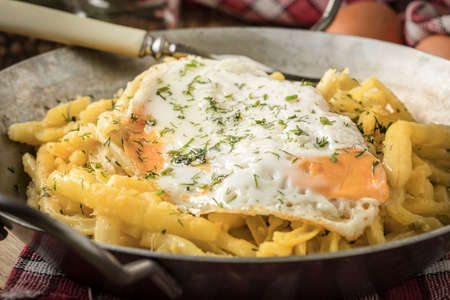 Fried egg served with yellow beans on pan.の写真素材