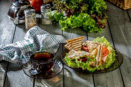 Panini sandwich with ham, tomato and lettuce  on a plate.の写真素材