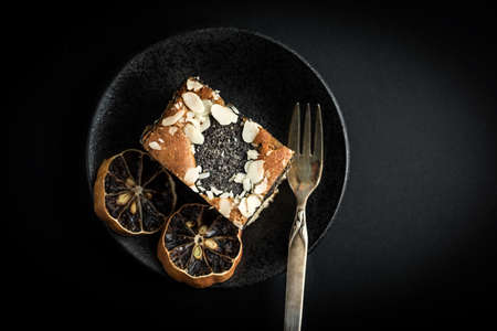 Poppy seed cake on a dark background. Dark light.の写真素材