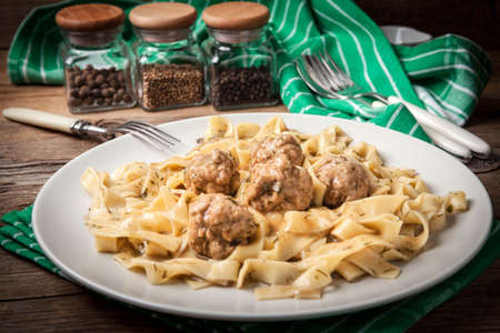 Tagliatelle pasta with pork meatballs and dill sauce. Selective focus.の写真素材