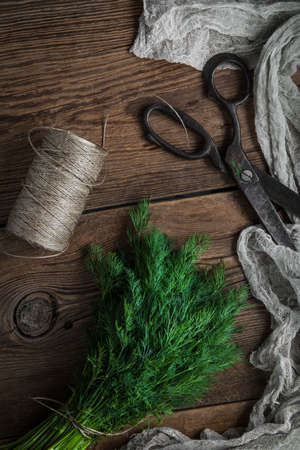 Dill. Fresh garden herbs on wooden table. Top view.の写真素材