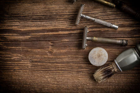Vintage barber shop tools on old wooden background. Small depth of field. Copy space.の写真素材