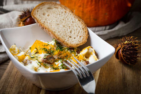 Tasty breakfast - scrambled eggs with sausage and bread.の写真素材