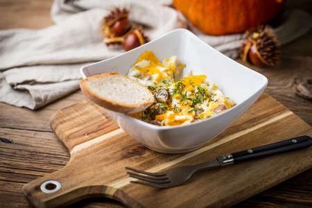 Tasty breakfast - scrambled eggs with sausage and bread.の写真素材
