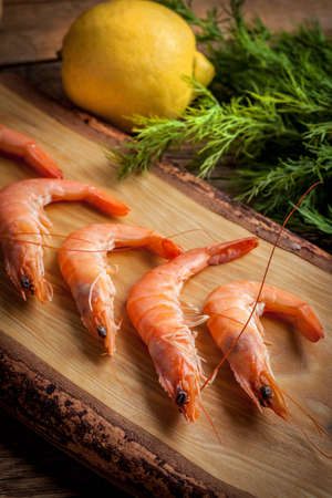 Shrimps for dinner on cutting board. Selective focus.の写真素材
