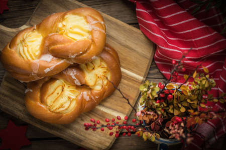 Sweet buns with cheese on a chopping board. Small depth of field.の写真素材