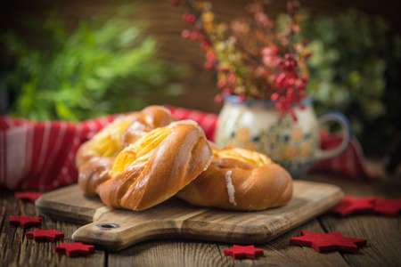 Sweet buns with cheese on a chopping board. Small depth of field.