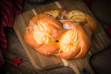Sweet buns with cheese on a chopping board. Small depth of field.の写真素材