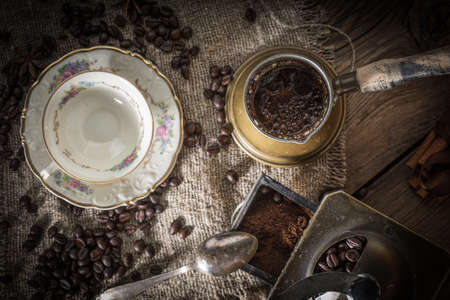 Turkish coffee in copper coffee pot on wooden background.の写真素材