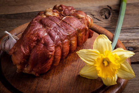 Delicious smoked ham on a wooden board.の写真素材