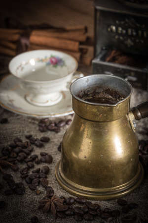 Turkish coffee in copper coffee pot on wooden background.の写真素材
