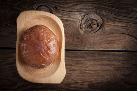 Traditional sweet donut on a wooden table.