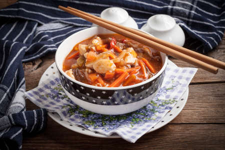 Chinese chicken with vegetables on wooden table. Selective focus.の写真素材